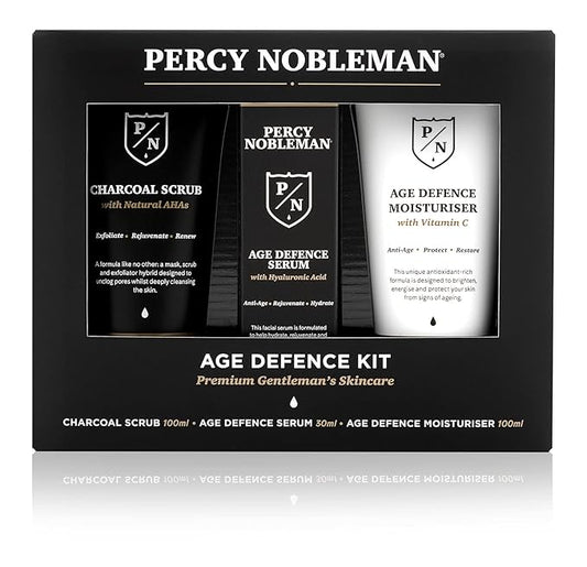 Age Defence Kit, a men's skincare set containing Charcoal Face Scrub (with Natural AHAs), ultra-hydrating Facial Serum (with Hyaluronic Acid), and Moisturiser (with Vitamin C)